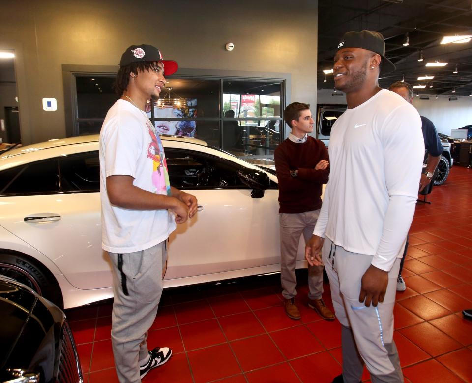 Ohio State quarterback CJ Stroud, left, speaks with Cleveland Browns linebacker Jacob Phillips, right, at Sarchione Auto Gallery in Jackson Township on Wednesday, June 8, 2022.