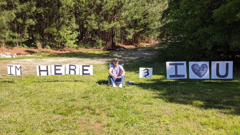 Mr Crockell sits with his signs outside his wife's hospital room. Source: Dennis Cockrell