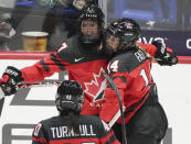 Canada's Laura Stacey (7) celebrates after her goal over Czechia with teammates Renata Fast (14) and Blayre Turnbull (40) during the third period of a hockey match at the IIHF Women's World Championships in Utica, N.Y., Sunday, April 7, 2024. (Christinne Muschi/The Canadian Press via AP)