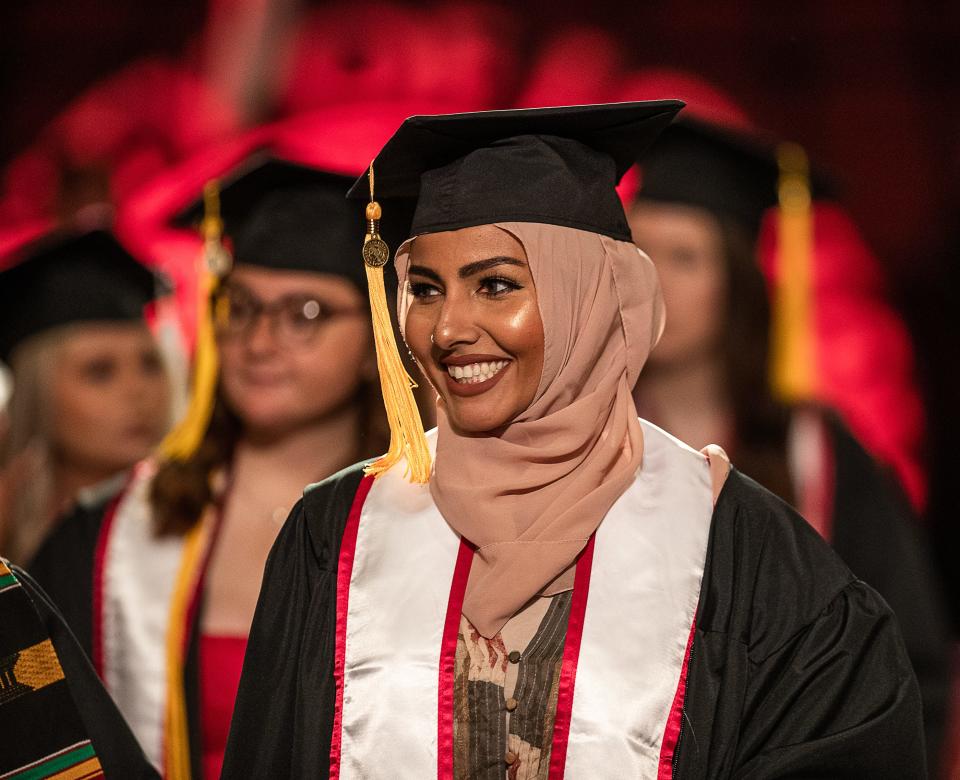 Graduates smiled as they took their seat before the University of Louisville graduation ceremonies at the KFC Yum Center on Saturday morning. May 13, 2023