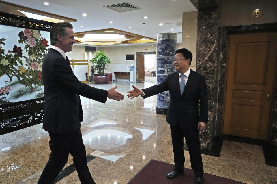 California Gov. Gavin Newsom, left, shakes hands with Zheng Shanjie, head of China's National Development and Reform Commission, in Beijing, Wednesday, Oct. 25, 2023. Newsom also met with China's senior most diplomat Wang Yi on Wednesday and displayed a brief moment of friendliness that stands in sharp contrast to the dialogue between the U.S. and China in recent years. (AP Photo/Ng Han Guan)
