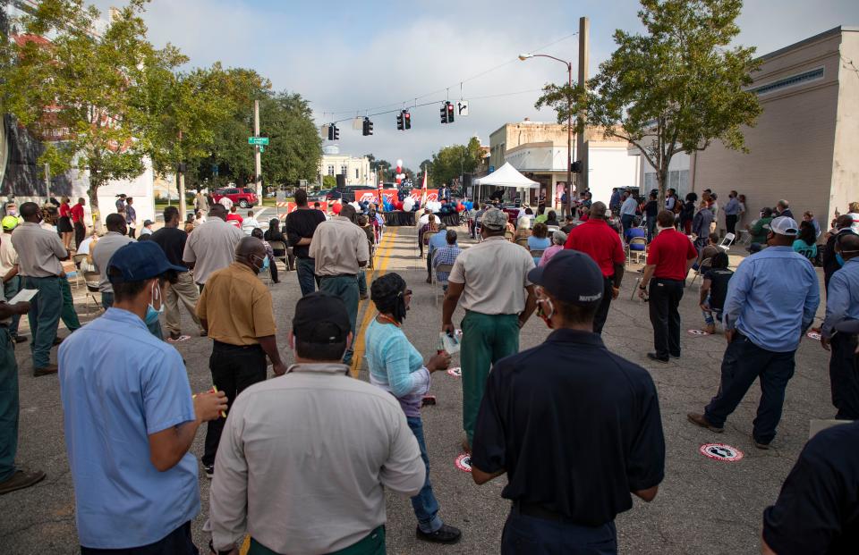 More than 100 people gathered in downtown Quincy, Florida for the unveiling of the newly restored Coca-Cola mural located on the side of Padgett's Jewelers on Tuesday, Oct. 13, 2020.