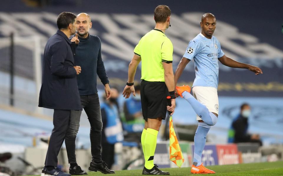 Manchester City manager Pep Guardiola (second left) exchanges words with FC Porto manager Sergio Conceicao  - PA