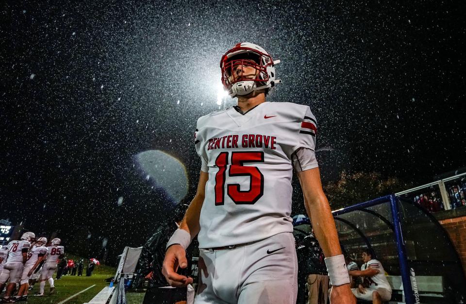 Center Grove Trojans quarterback Tyler Cherry (15) walks along the sidelines Friday, Oct. 13, 2023, during the game at Butler University in Indianapolis. The Center Grove Trojans defeated the Cathedral Fighting Irish, 45-38.