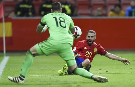 Football Soccer - Spain v Israel - 2018 World Cup Qualifying European Zone - Group G - El Molinon Stadium, Gijon, Spain, 24/3/17 Spain's Dani Carvajal (R) and Israel's goalkeeper Ofir Marciano in action. REUTERS/Eloy Alonso