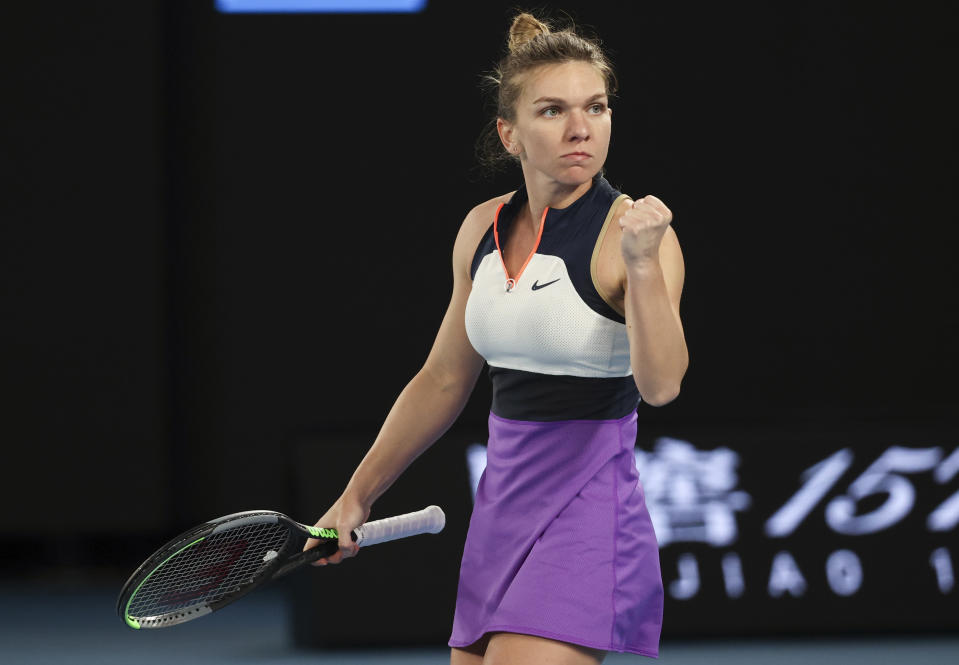 Romania's Simona Halep celebrates a point win over Poland's Iga Swiatek during their fourth round match at the Australian Open tennis championship in Melbourne, Australia, Sunday, Feb. 14, 2021.(AP Photo/Hamish Blair)