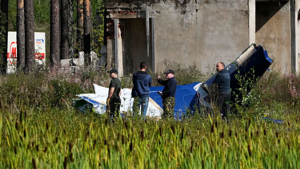 Russian servicemen inspect part of the crashed private jet near the village of Kuzhenkino, Tver region, Russia, on Thursday, August 24. - Alexander Zemlianichenko/AP