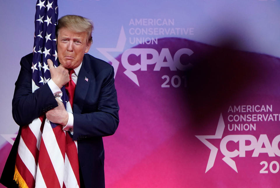 President Donald Trump hugs the U.S. flag as he arrives to speak at the Conservative Political Action Conference (CPAC) annual meeting at National Harbor in Oxon Hill, Md., on March 2, 2019. (Photo: Joshua Roberts/Reuters)