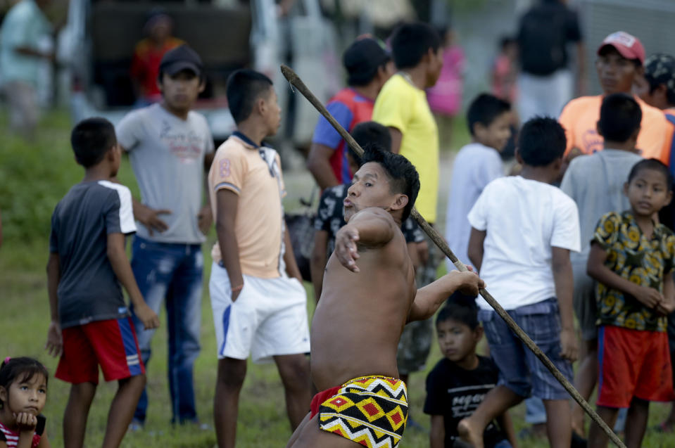 In this Nov. 25, 2018 photo, an Embera indigenous man takes part in the spear throwing competition during the second edition of the Panamanian indigenous games in Piriati, Panama. The Embera are an indigenous people of Panama and Colombia. (AP Photo/Arnulfo Franco)