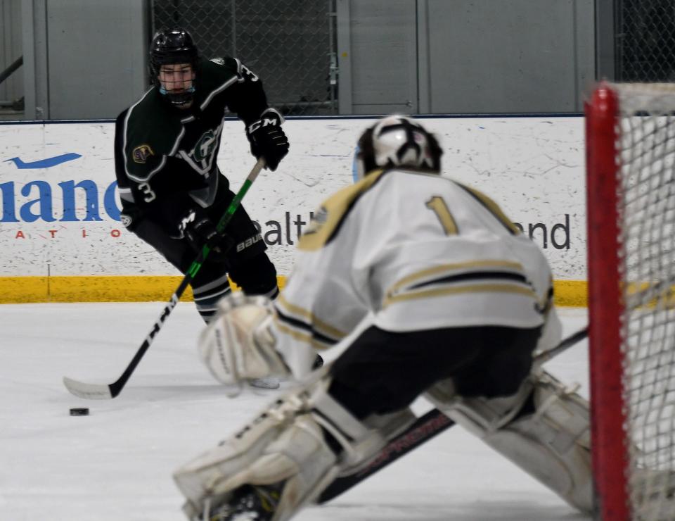 Grafton's Roman Gilliatt lines up a shot toward St. Paul goalie Chris Palermo during Wednesday's game at the Worcester Ice Center.