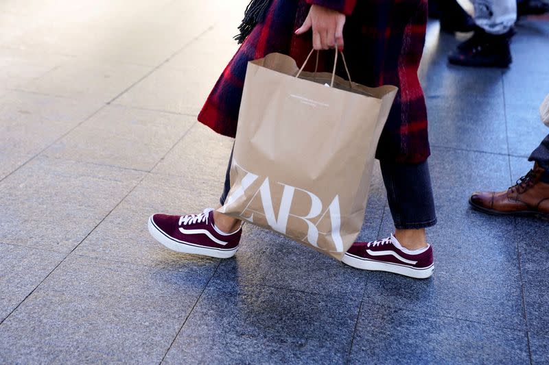 FILE PHOTO: A shopper carries a bag from Zara clothes store in Bilbao