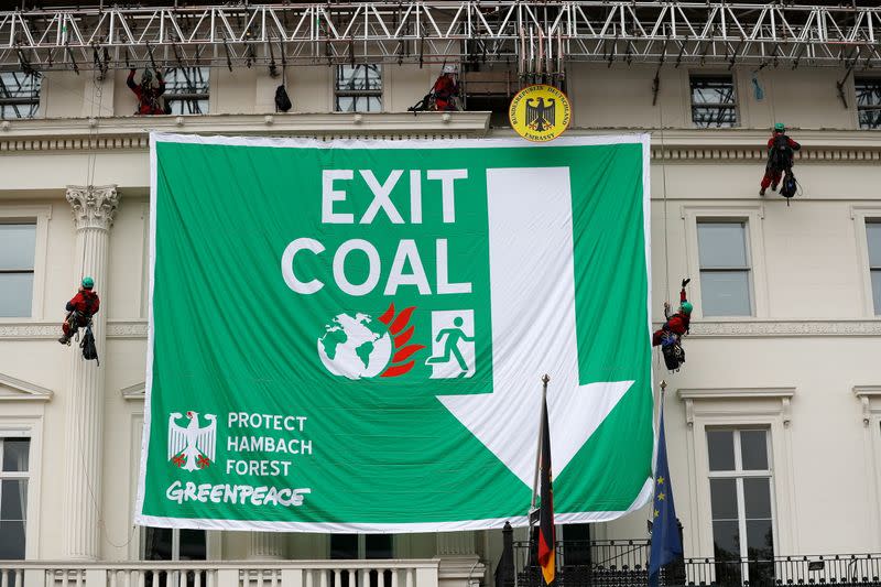 FILE PHOTO: Greenpeace activists abseil down the facade of Germany's embassy as they unfurl a banner against coal, in London