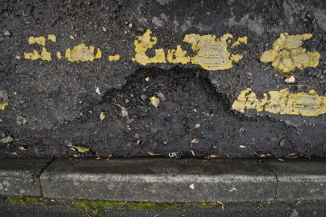 Yellow lines and a crumbling road surface is seen near the city Centre of Gloucester, as most of the roads South West UK are left in need of repair and resurfacing work after a year of heavy rainfall and recent flooding, creating potholes and debris. PRESS ASSOCIATION Photo. Picture date: Sunday January, 6, 2013. Photo credit should read: Ben Birchall/PA Wire