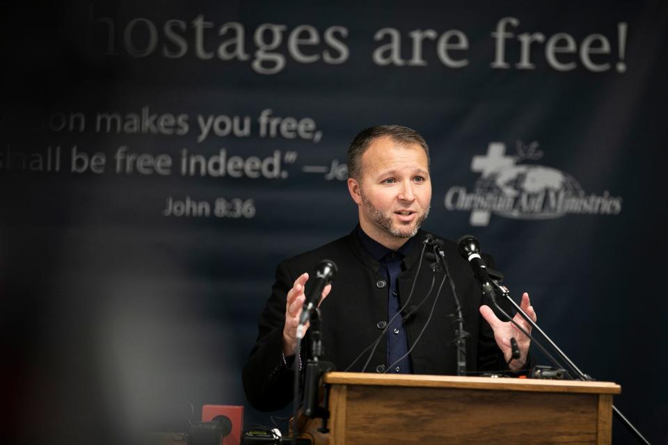 Weston Showalter with Christian Aid Ministries, becomes emotional as he tells the hostages' story, during a press conference at Christian Aid Ministries, in Berlin, Ohio, Monday, December 20, 2021. All 17 staff members of Christian Aid Ministries who were held hostage in Haiti by the 400 Mawozo gang, have returned home. The last 12 hostages escaped.