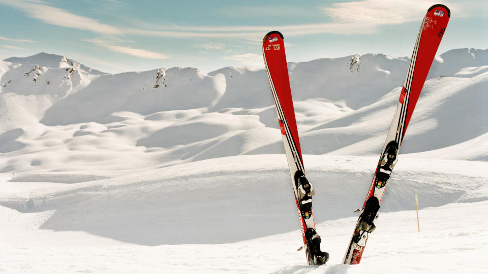 A pair of red skis in the snow