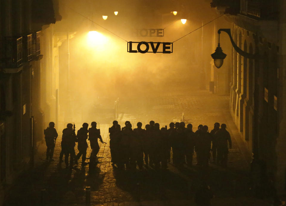 Special forces police fire tear gas as they advance to push back the anti-government protesters in downtown Beirut, Lebanon, Wednesday, Jan. 22, 2020. Lebanon's new government, made up of members nominated by the Shiite group Hezbollah and its allies got down to business Wednesday, a day after it was formed. Questions arose immediately about its ability to halt a spiral of economic and political collapse. (AP Photo/Hussein Malla)