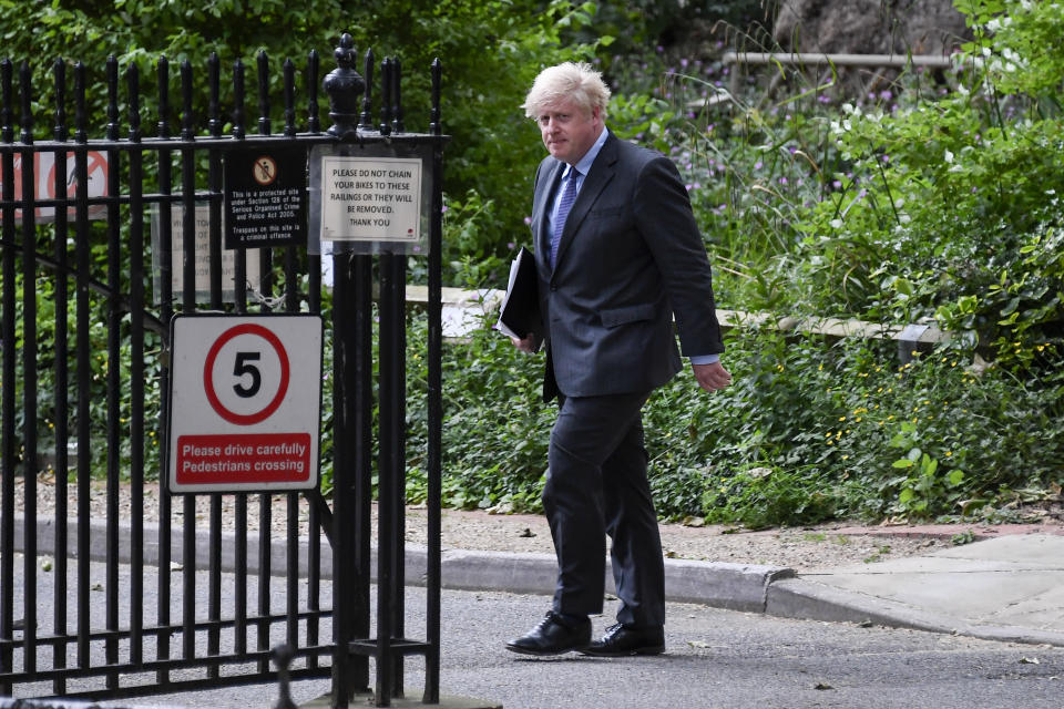 Britain's Prime Minister Boris Johnson walks to 10 Downing Street after his press conference, in London, Monday, June 14, 2021. Johnson has confirmed that the next planned relaxation of coronavirus restrictions in England will be delayed by four weeks until July 19 as a result of the spread of the delta variant. In a press briefing Monday, Johnson said he is “confident that we won’t need more than four weeks” as millions more people get fully vaccinated against the virus, which could save thousands of lives. (AP Photo/Alberto Pezzali)