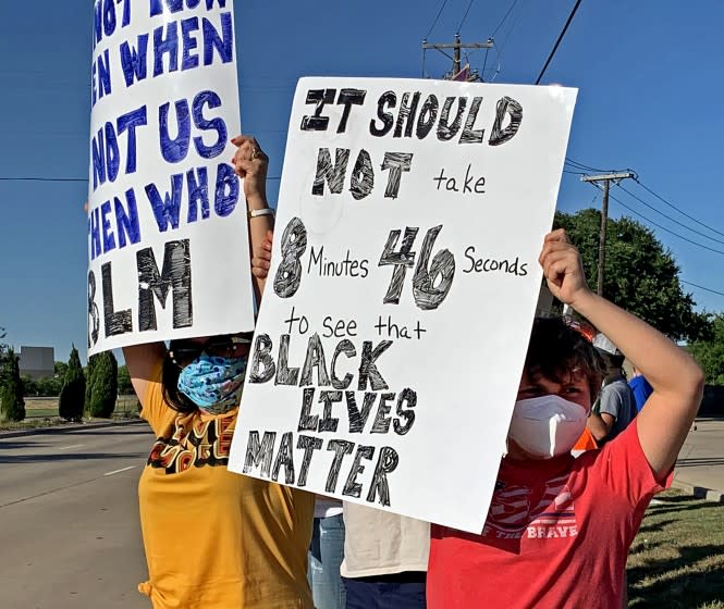 Mike Sexton's wife and son, Lee Anne, left, and Tyler, 11, during a unity rally outside Grapevine, Texas, that Sexton organized to protest excessive use of force and racial bias in policing. (Courtesy of Mike Sexton)