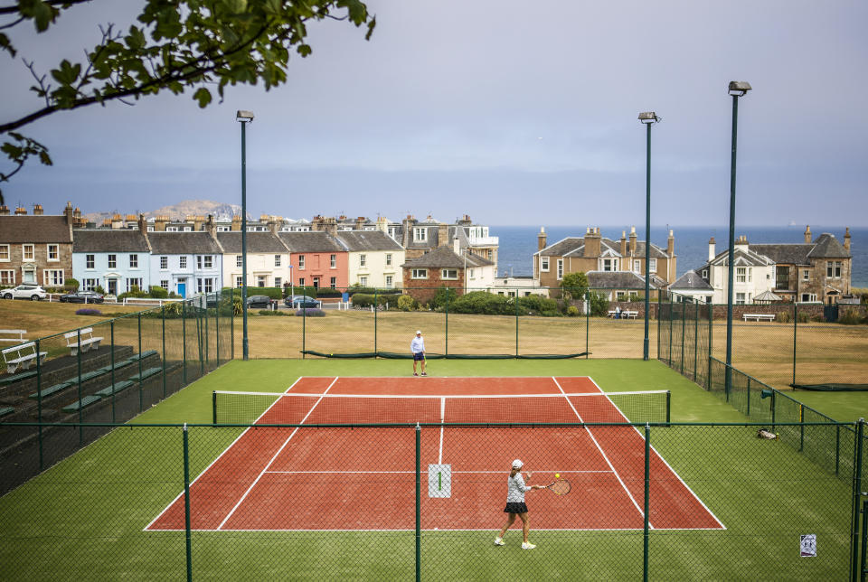 People play tennis at North Berwick Tennis Club, as people can meet family and friends outdoors and play sports such as golf and tennis again as Scotland is moving into phase one of the Scottish Government's plan for gradually lifting lockdown.