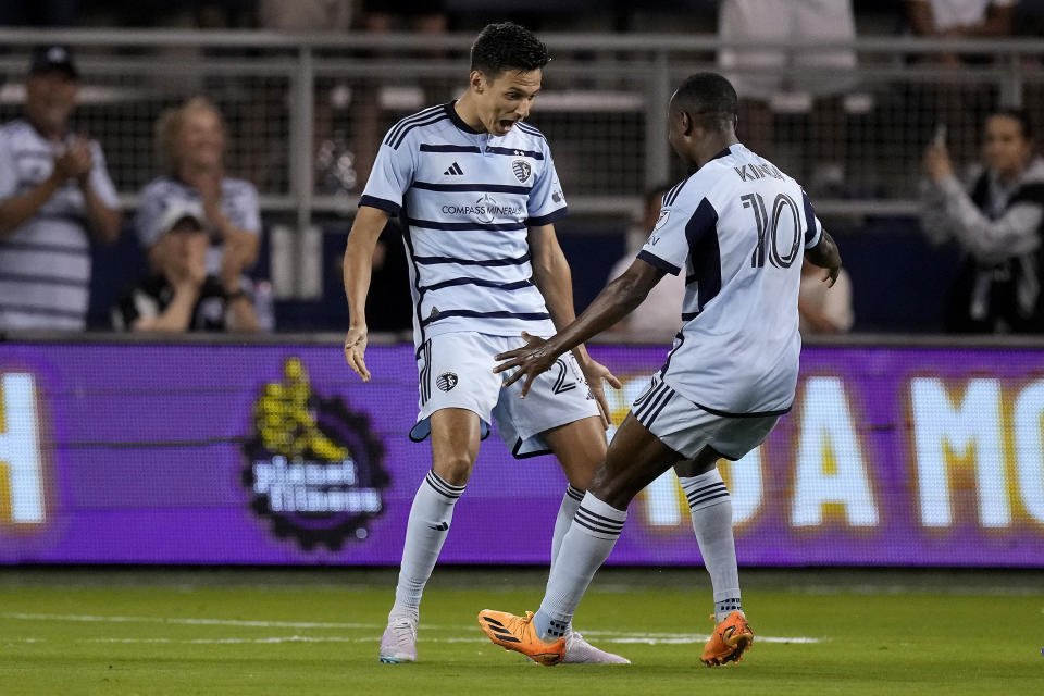 Sporting Kansas City midfielder Gadi Kinda (10) celebrates with forward Dániel Sallói after scoring a goal during the first half of an MLS soccer match against FC Dallas Wednesday, May 31, 2023, in Kansas City, Kan. (AP Photo/Charlie Riedel)