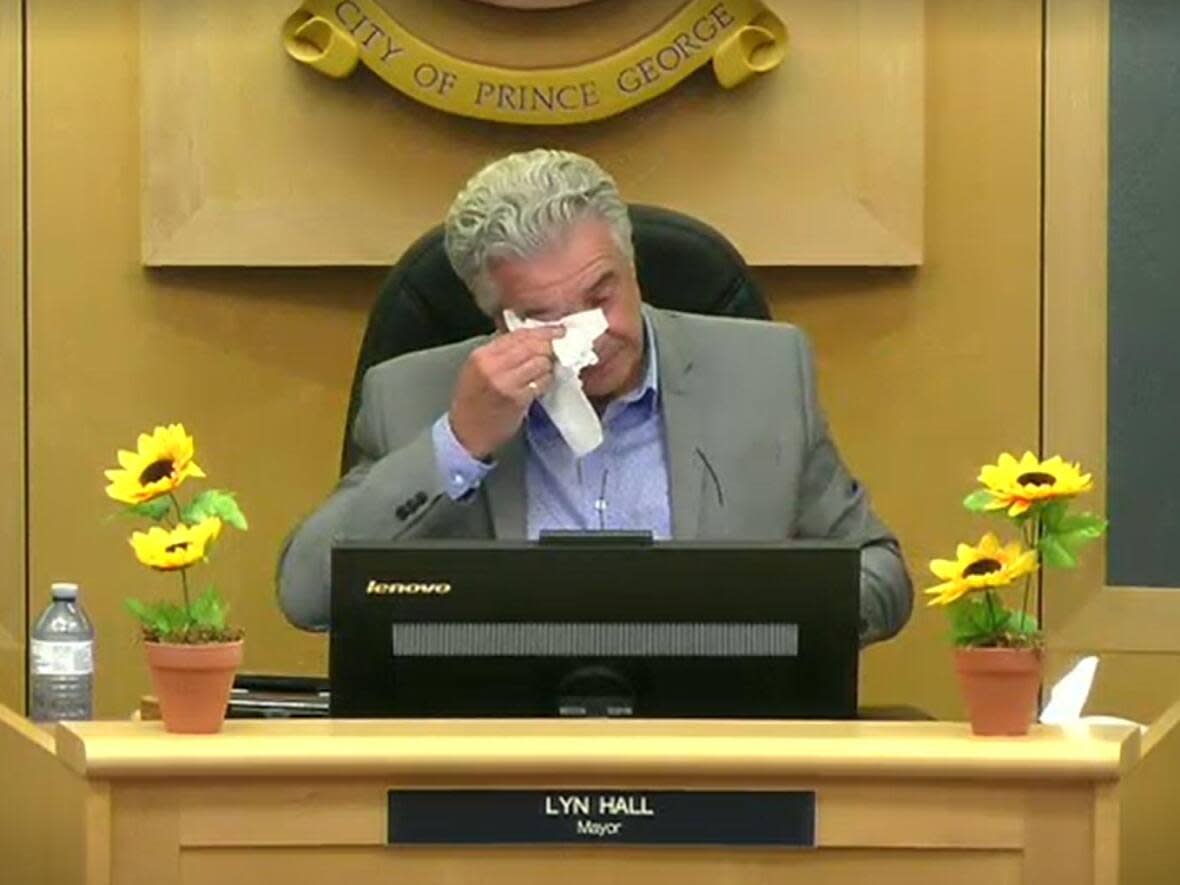 Prince George, B.C. Mayor Lyn Hall wipes away tears after announcing Monday evening that he won't be seeking re-election in the fall.  (City of Prince George - image credit)