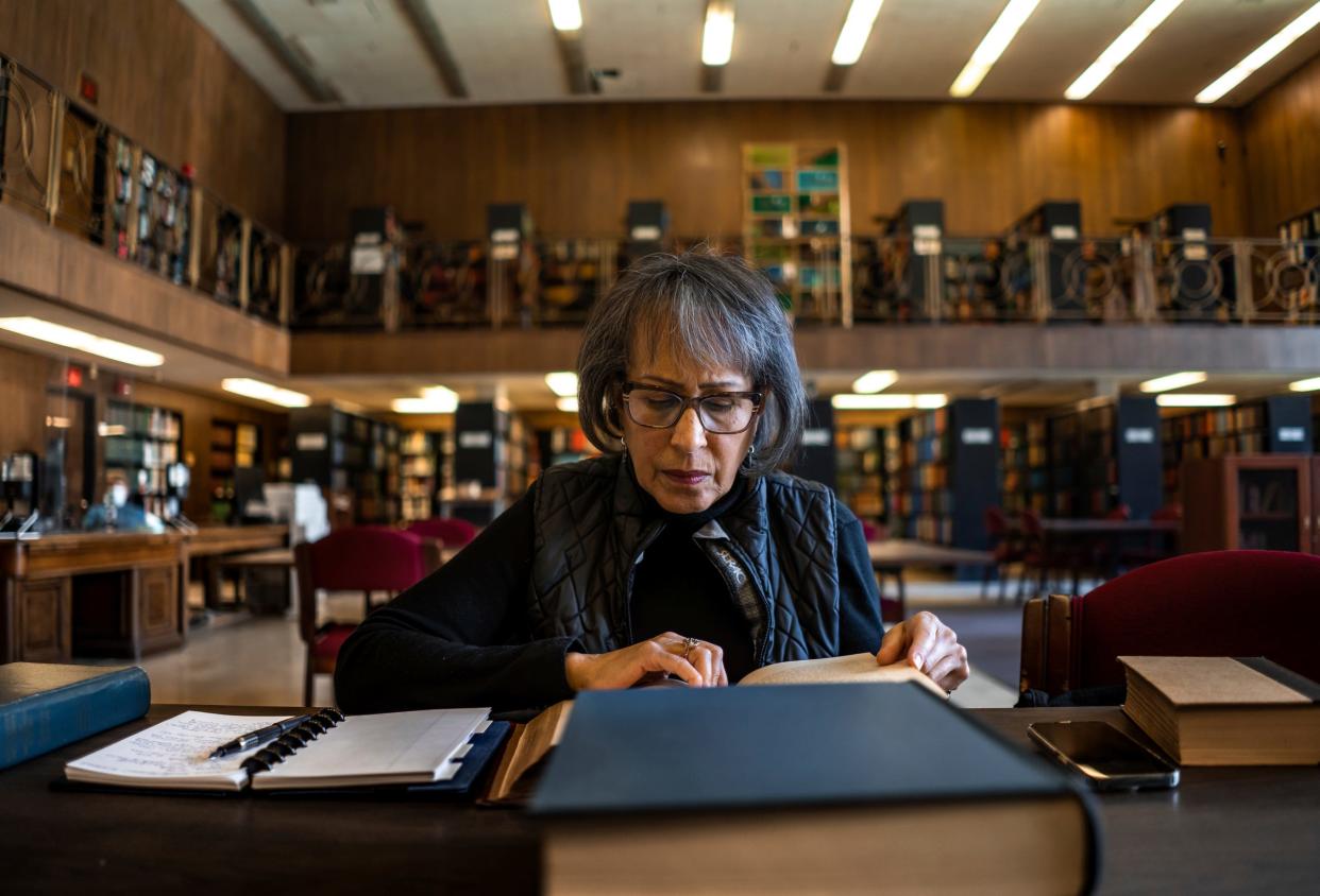 Detroit native Karen Batchelor of Southfield looks for record books from New York while researching a long-standing genealogy brick wall to try to connect a family member to his father she believes was a Revolutionary War soldier, at the Burton Historical Collection of the Detroit Public Library on Wednesday, March 15, 2023.