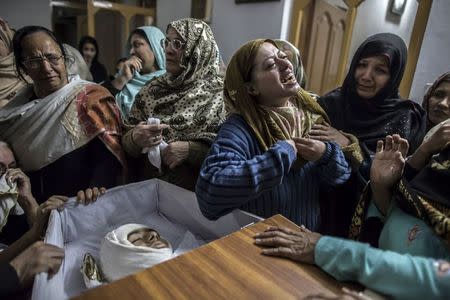 A mother mourns her son Mohammed Ali Khan, 15, a student who was killed during an attack by Taliban gunmen on the Army Public School, at her house in Peshawar December 16, 2014. At least 132 students and nine staff members were killed on Tuesday after Taliban gunmen broke into a school in the Pakistani city of Peshawar and opened fire, witnesses said, in the bloodiest massacre the country has seen for years. REUTERS/Zohra Bensemra