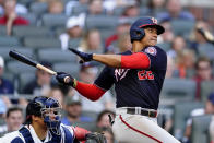 Washington Nationals' Juan Soto (22) follows through on a base bit in the fifth inning of a baseball game against the Atlanta Braves, Monday, May 31, 2021, in Atlanta. Braves catcher William Contreras, left, looks on. (AP Photo/John Bazemore)