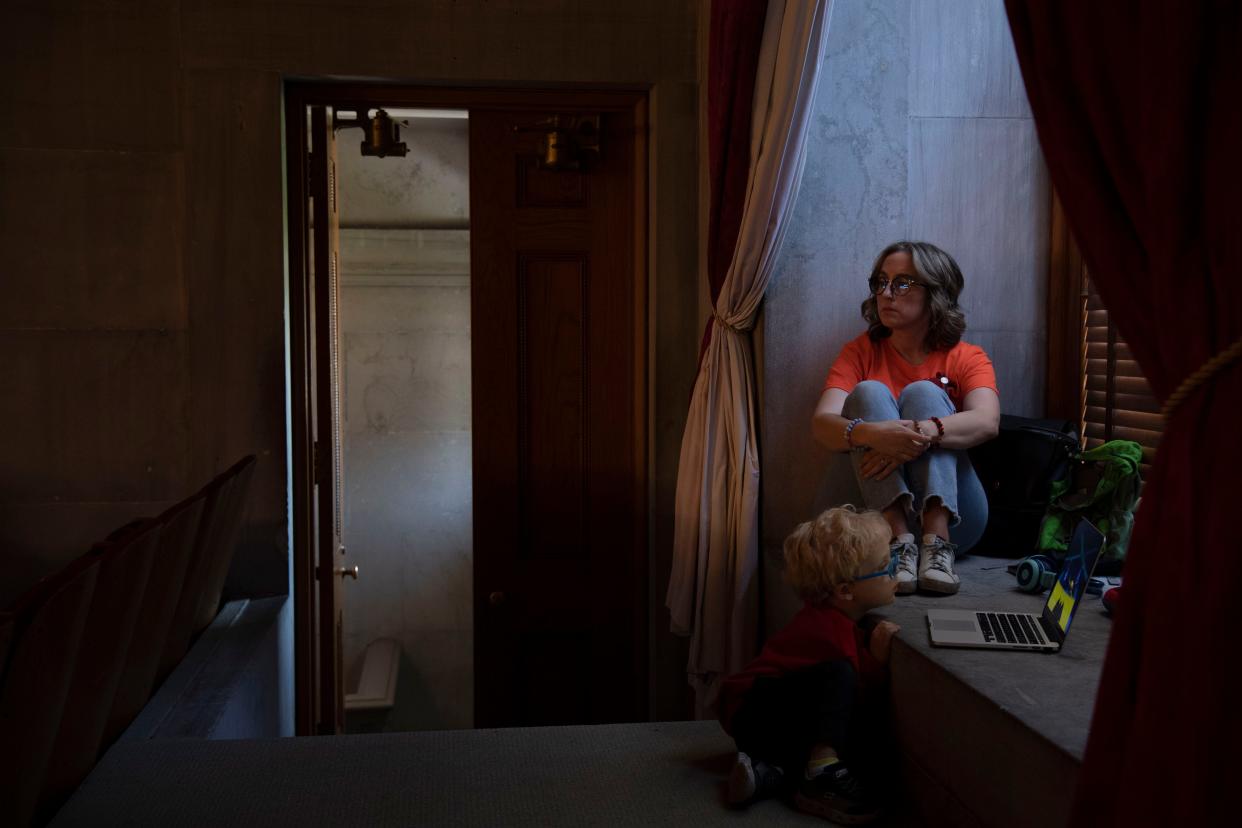 Sarah Shoop Neumann, a Covenant parent, listens during a House session with her son, Judah at the Tennessee Capitol in Nashville , Tenn., Monday, April 22, 2024.