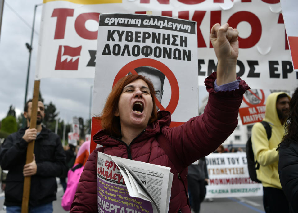 A protester shouts slogans during a rally in Athens, Greece, Wednesday, Feb. 28, 2024. Widespread strikes in Greece disrupted transport services Wednesday, halting ferries and trains, in protests timed to coincide with the anniversary of a deadly rail crash a year ago. (AP Photo/Michael Varaklas)