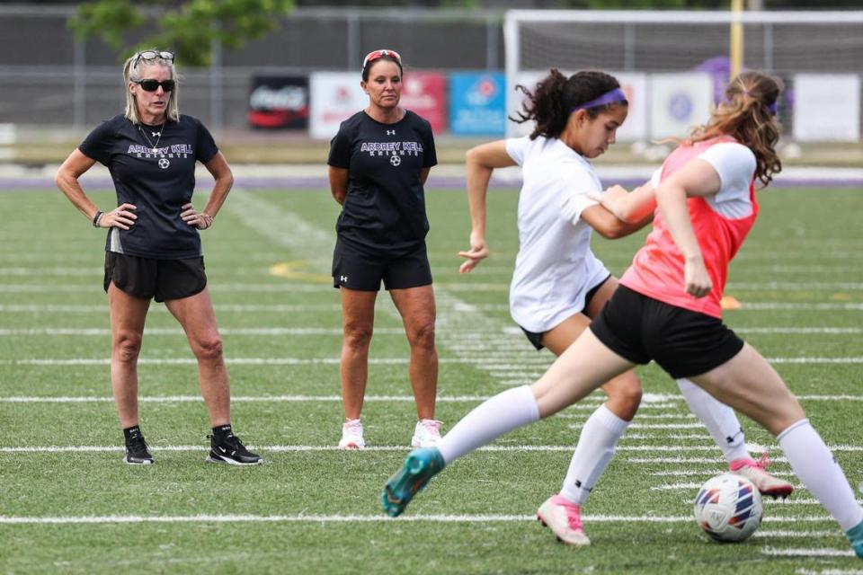 Audrey Kell girls soccer head coach Kim Montgomery, far left, watches the team run drills during practice on Friday, March 12, 2023.