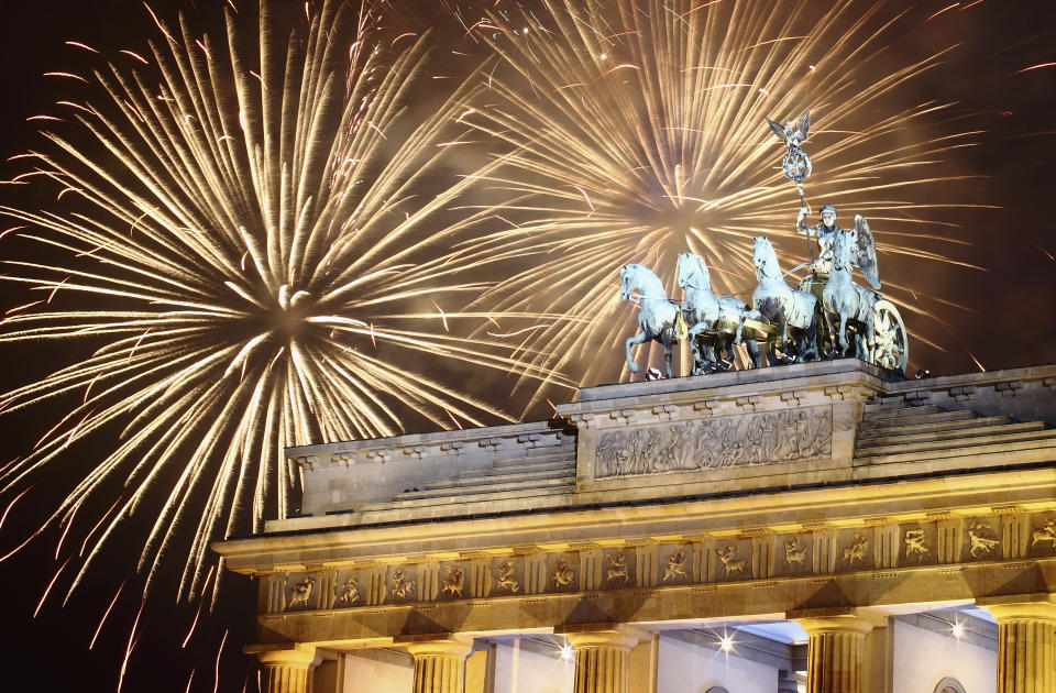 BERLIN, GERMANY - JANUARY 01: Fireworks explode over the Quadriga statue atop the Brandenburg Gate on New Year's Eve on January 1, 2012 in Berlin, Germany. According to the media, up to one million people celebrate the country's biggest New Year's Eve Party. (Photo by Andreas Rentz/Getty Images)