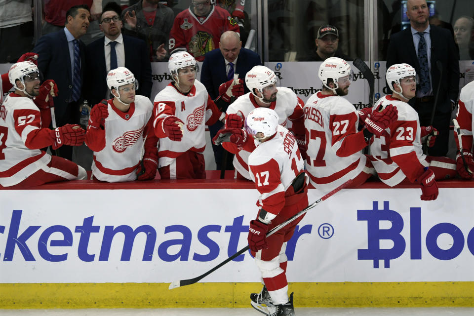 Detroit Red Wings' Daniel Sprong (17) celebrates with teammates at the bench after scoring during the first period of an NHL hockey game against the Chicago Blackhawks, Sunday, Feb. 25, 2024, in Chicago. (AP Photo/Paul Beaty)