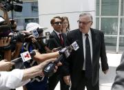 FILE - In this June 26, 2017, former Maricopa County Sheriff Joe Arpaio, right, leaves U.S. District Court on the first day of his contempt-of-court trial in Phoenix. Arpaio is running again to get back his old job as sheriff of metro Phoenix. His 24 years as sheriff were defined by a series of tough-on-crime tactics and legal problems that cost taxpayers millions of dollars. (AP Photo/Ross D. Franklin, File)