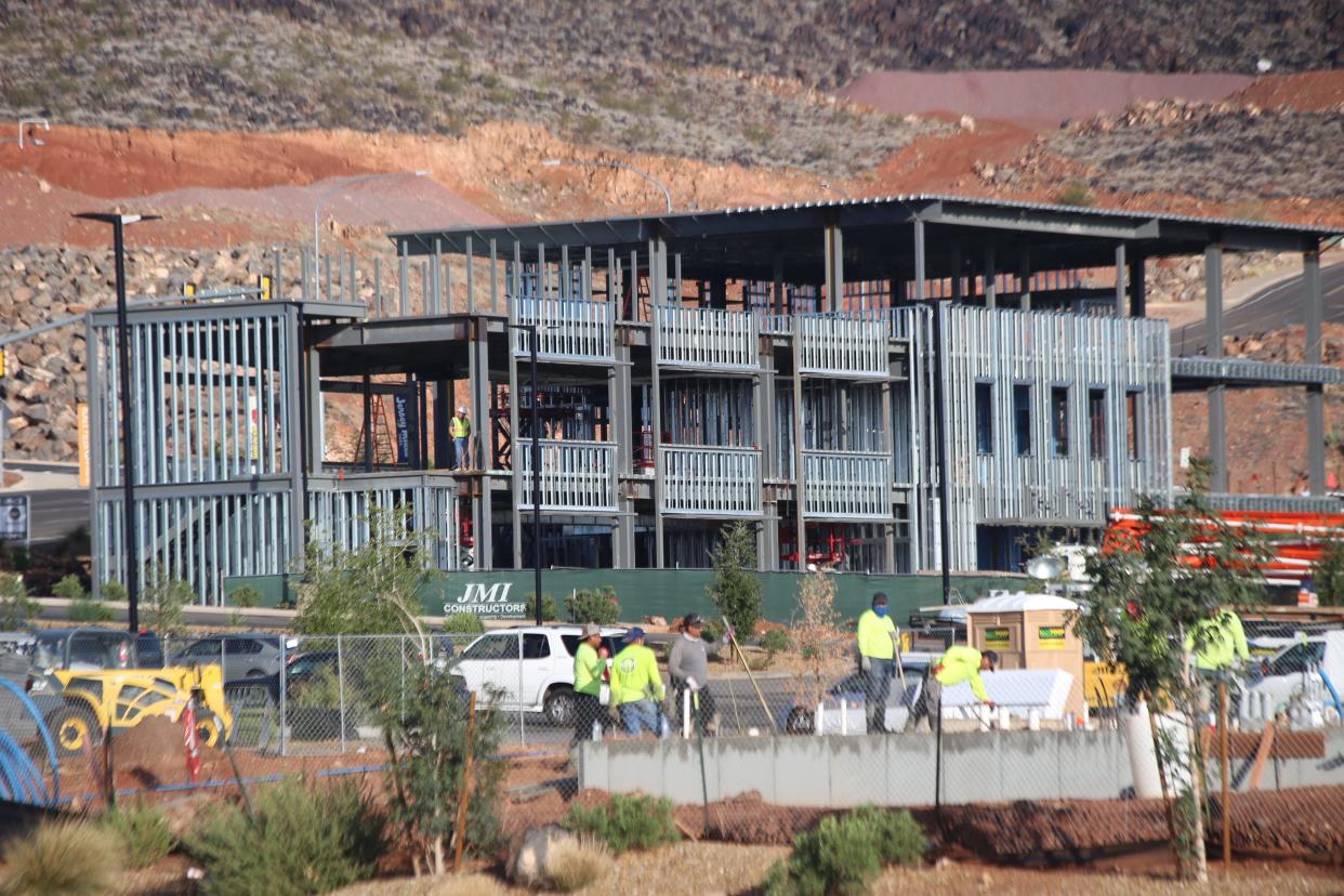 Crews work on construction of a new commercial building near Blackridge Drive in St. George.