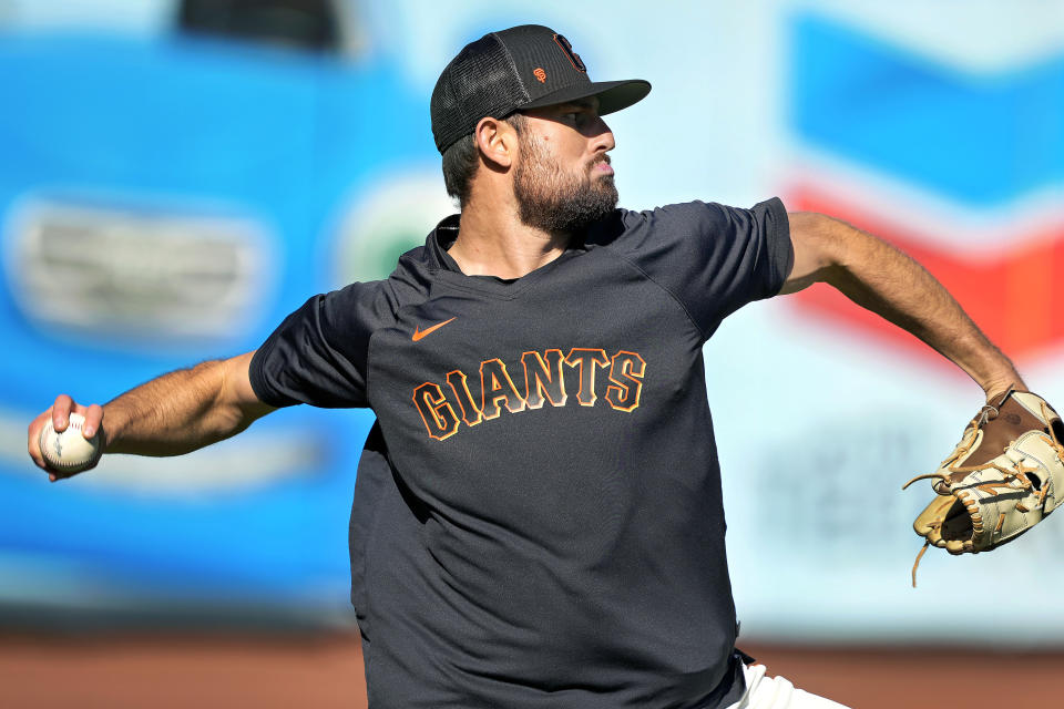 San Francisco Giants pitcher Tristan Beck warms up before making his big-league baseball debut in a game against the New York Mets on Thursday, April 20, 2023, in San Francisco. Tiffany Fuentes and her family hosted San Jose Giants players from 2012 to 2019, including six future big leaguers. The Fuentes family was present when Beck made his big-league debut.(AP Photo/Tony Avelar)