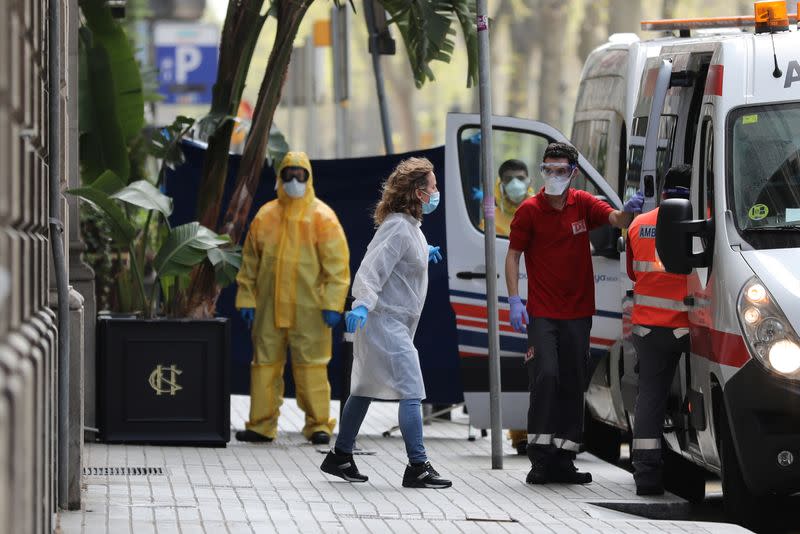 Medical workers are seen outside the Cotton House Hotel in Barcelona