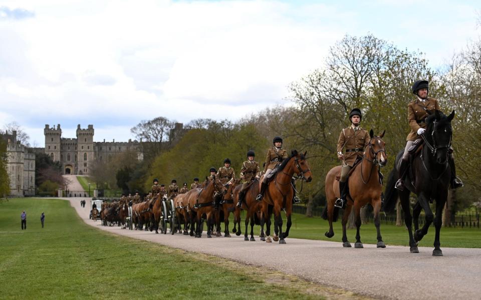 Members of the King's Troop, Royal Horse Artillery, ride along the Long Walk outside Windsor Castle transporting three guns in preparation for the funeral ceremony - Andy Rain/EPA-EFE/Shutterstock