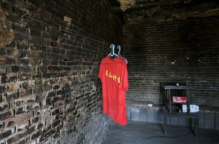 A shirt is seen in a deserted dormitory for brick workers at a closed brick factories on the outskirts of Beijing, China, January, 18, 2016. REUTERS/Jason Lee