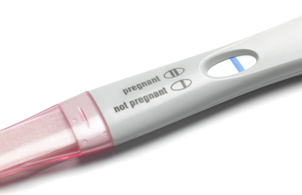 Pregnancy test showing a positive result with one blue line next to 'pregnant'