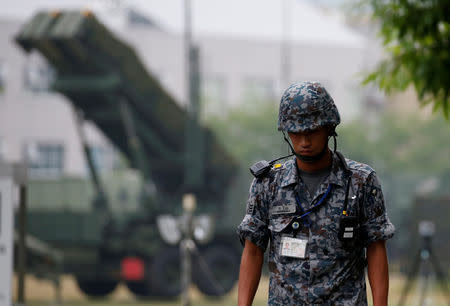 A Japan Self-Defense Forces soldier guards near a unit of Patriot Advanced Capability-3 (PAC-3) missiles at the Defense Ministry in Tokyo, Japan June 22, 2016. REUTERS/Toru Hanai/Files