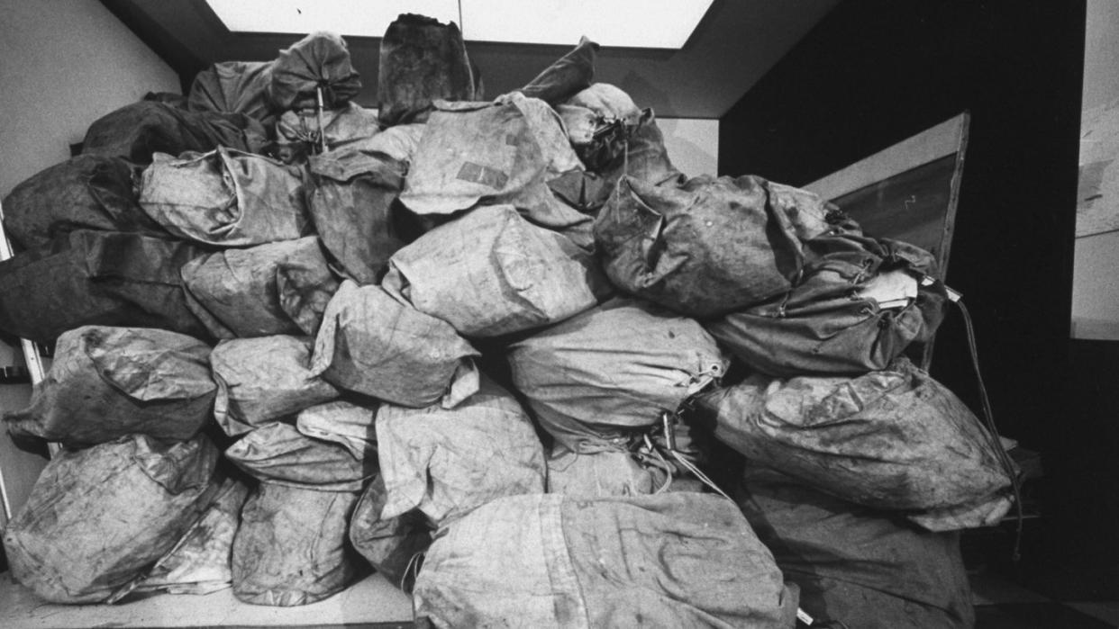 distant close up views of mail bags containing enteries for the life photo contest mailbags stacked from floor to ceiling bulging put of office door photo by john olsonthe life picture collection via getty images