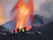 Scientists from CSIC (Spanish National Research Council) take geophysics measurements on the Canary Island of La Palma, Spain, Saturday, Nov. 13, 2021. They come with eagle-eyed drones and high-precision spectrometers. Aided by satellites, they analyze gas emissions and the extent and direction of molten rock flows. And, on the ground, they collect everything from nanoparticles to 'lava bombs' the size of watermelons that one of nature's most powerful forces hurl as incandescent projectiles. (AP Photo/Taner Orribo)