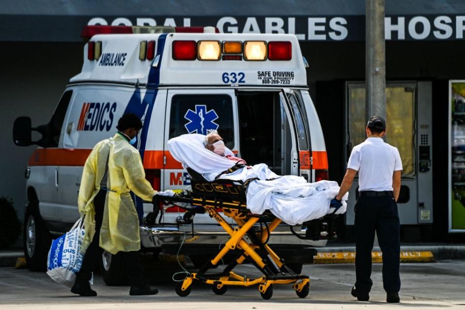 A patient on a stretcher being transferred from an ambulance outside Emergency at Coral Gables Hospital.