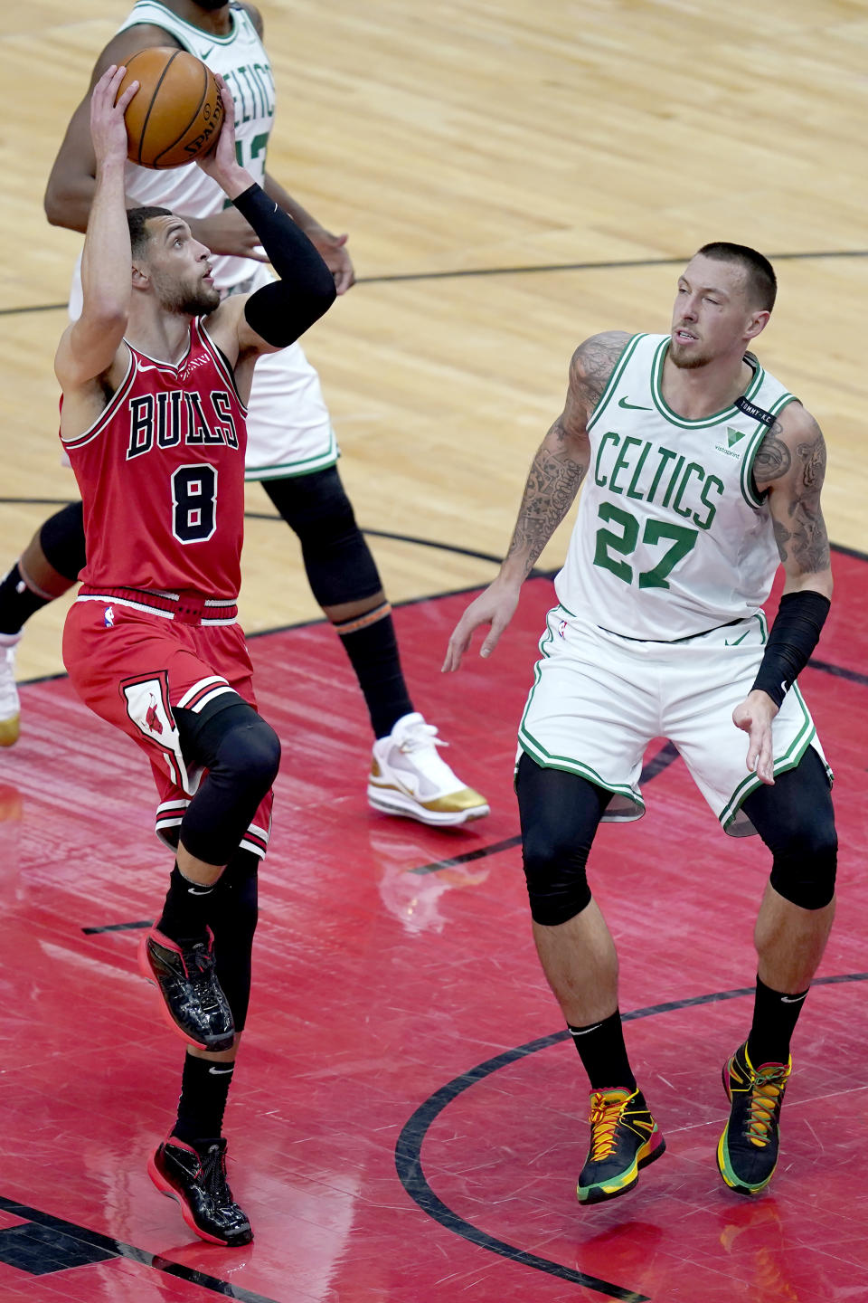 Chicago Bulls' Zach LaVine shoots over Boston Celtics' Daniel Theis during the second half of an NBA basketball game Monday, Jan. 25, 2021, in Chicago. (AP Photo/Charles Rex Arbogast)