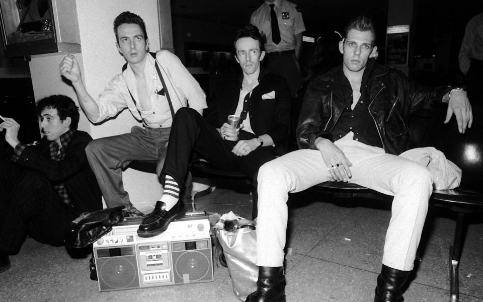 (L-R) Mick Jones, Joe Strummer, Topper Headon and Paul Simonon at John F. Kennedy International Airport in 1981 - AP