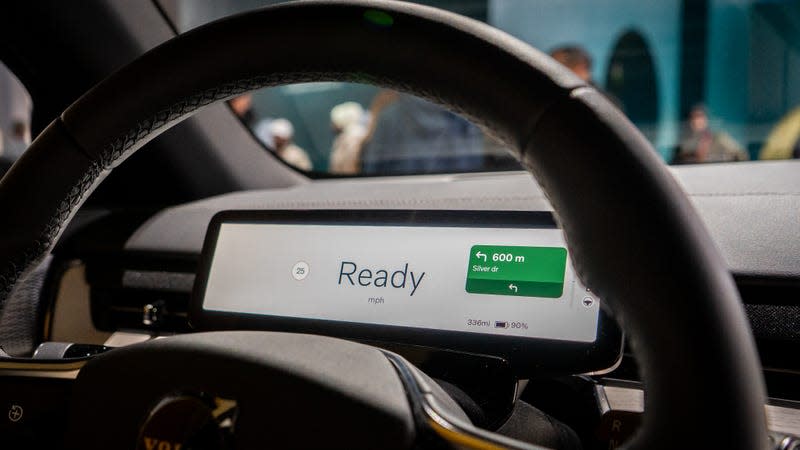 A photo of Google Maps behind a wheel in a car