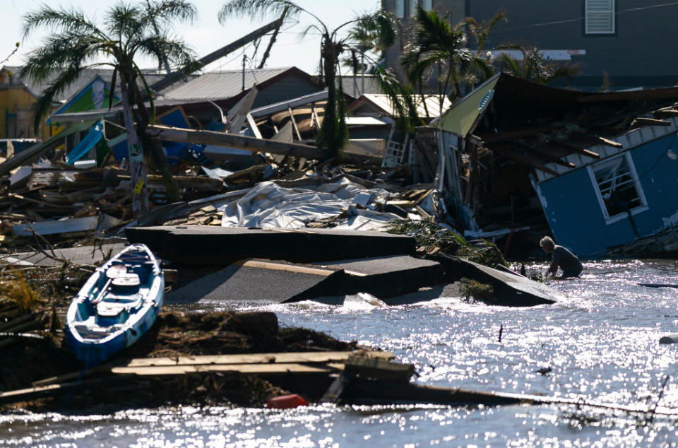 <div class="inline-image__caption"><p>A man moves through gulf water flowing through a broken section of Pine Island Road a day after Hurricane Ian made landfall.</p></div> <div class="inline-image__credit">Miami Herald/Getty Images</div>