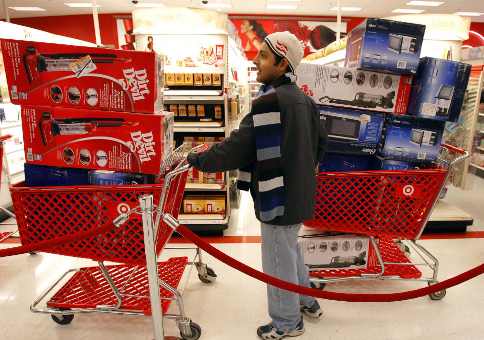 A man waits in line to check out at a Target store on Black Friday in Lanesborough, Massachusetts November 26, 2010. (REUTERS/Adam Hunger) 