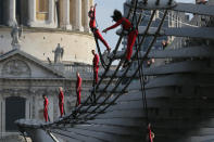 LONDON, ENGLAND - JULY 15: Dancers bungee off the Millennium Bridge as part of the 'One Extraordinary Day' performances on July 15, 2012 in London, England. The dancers are part of American choreographer Elizabeth Streb's 'extreem action' dance group which will perform around London for one day only and form part of the Cultural Olympiad. (Photo by Dan Kitwood/Getty Images)